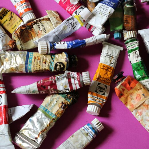 tubes of paint on a pink background